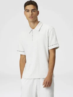 Polo en éponge de coton zigzag avec passepoil contrasté